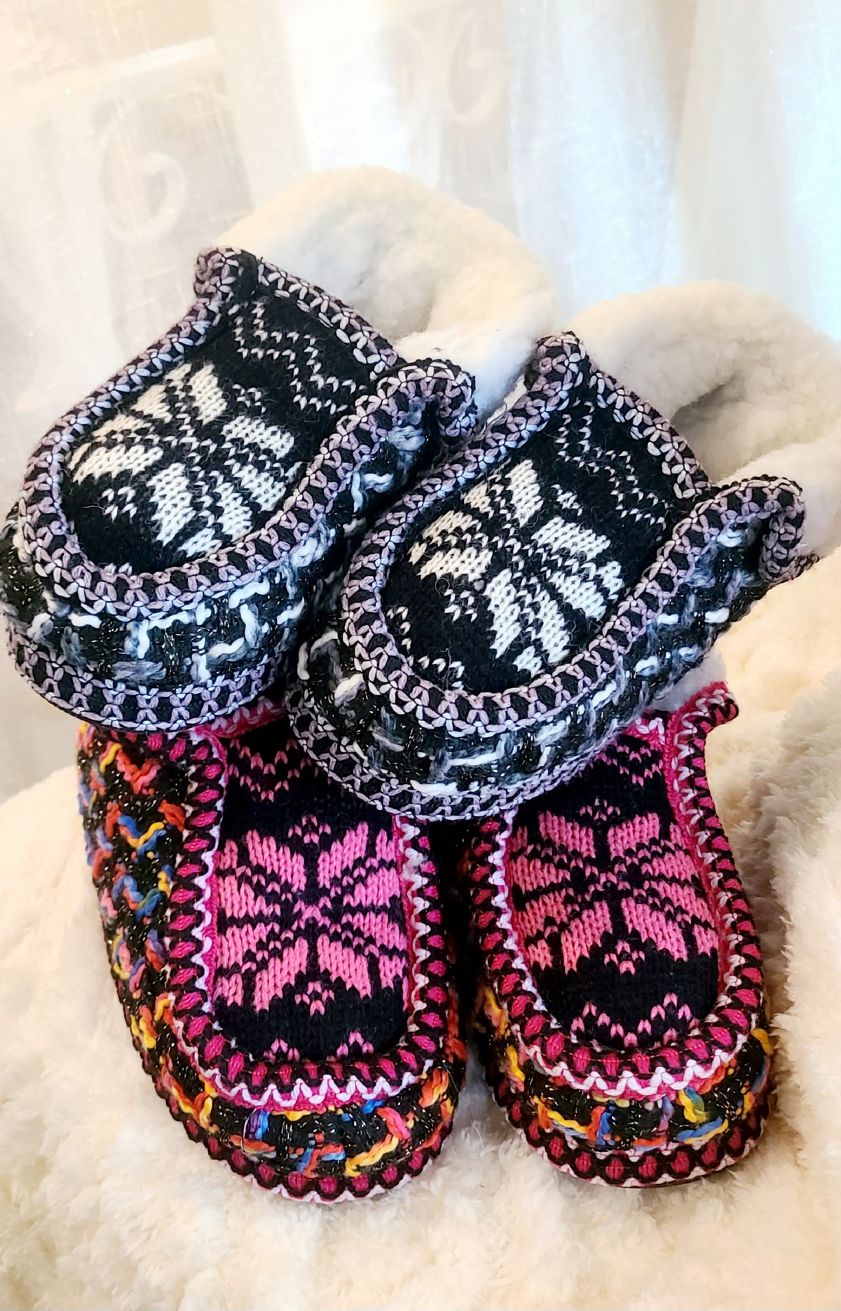 Kids natural and blue knit sherpa moccasin slippers, shown with a fuchsia pair