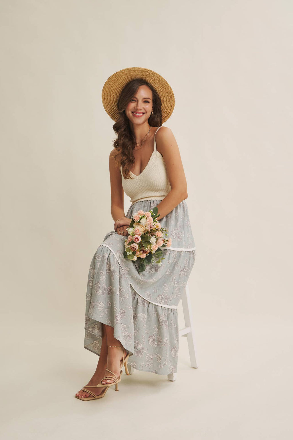 Women's ivory and dusty blue two-fer midi sundress, holding flowers
