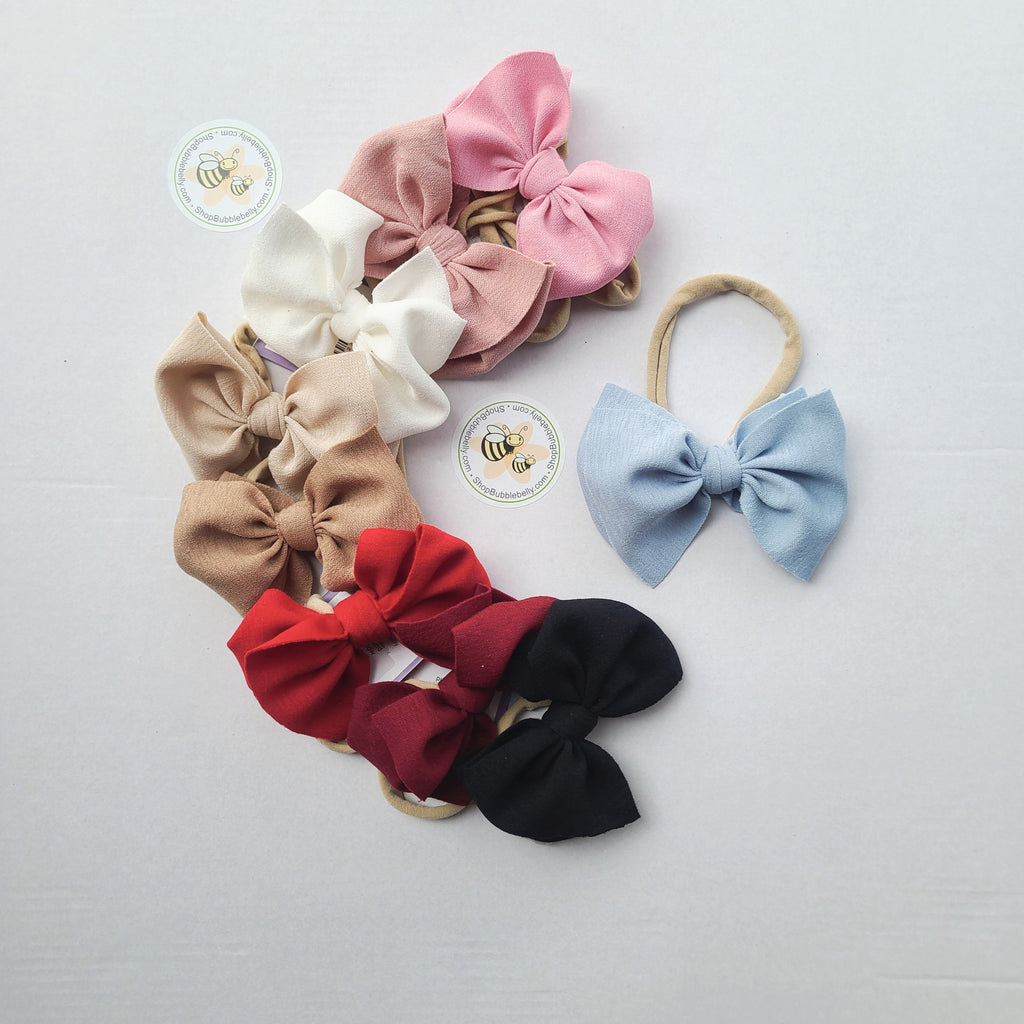 Stretchy fabric hair bows on nylon for babies and kids. Handmade hair bow.