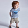 Boy Wearing tan linen short front view, shorts are relaxed and are adjustable 