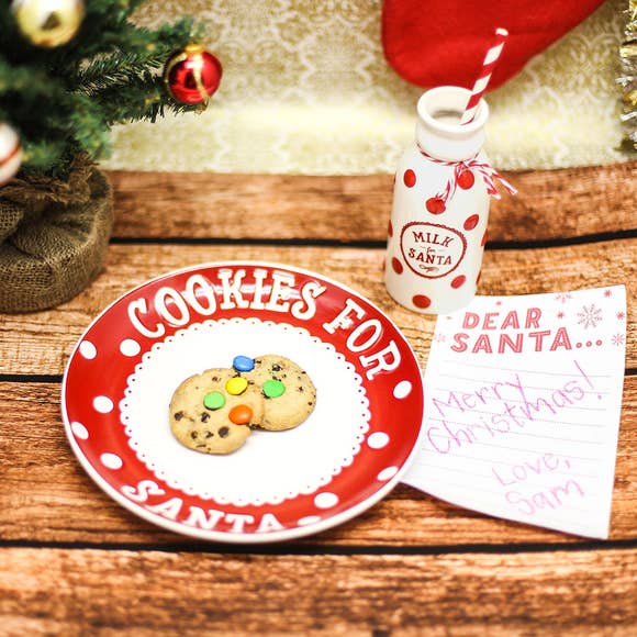 Cookies for Santa plate with cookies, filled milk jug and written wish list on Christmas Eve