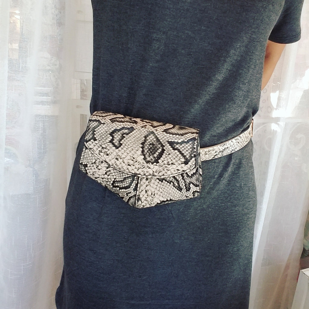Faux snakeskin fanny pack belt bag, black and tan, worn at waist
