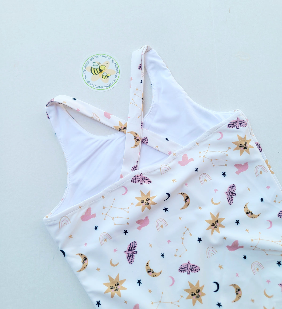 Girls criss cross zip swimsuit, sun moon and stars, back view