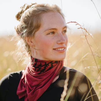 Women's hand-printed jersey bandana, black fern cinnamon, worn as neck scarf