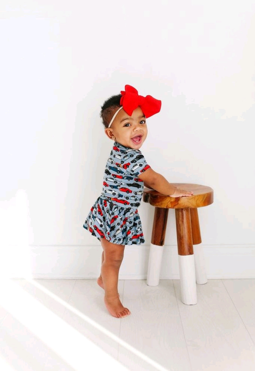 Posh Peanut twirl skirted bodysuit, Miles racecars, worn by toddler